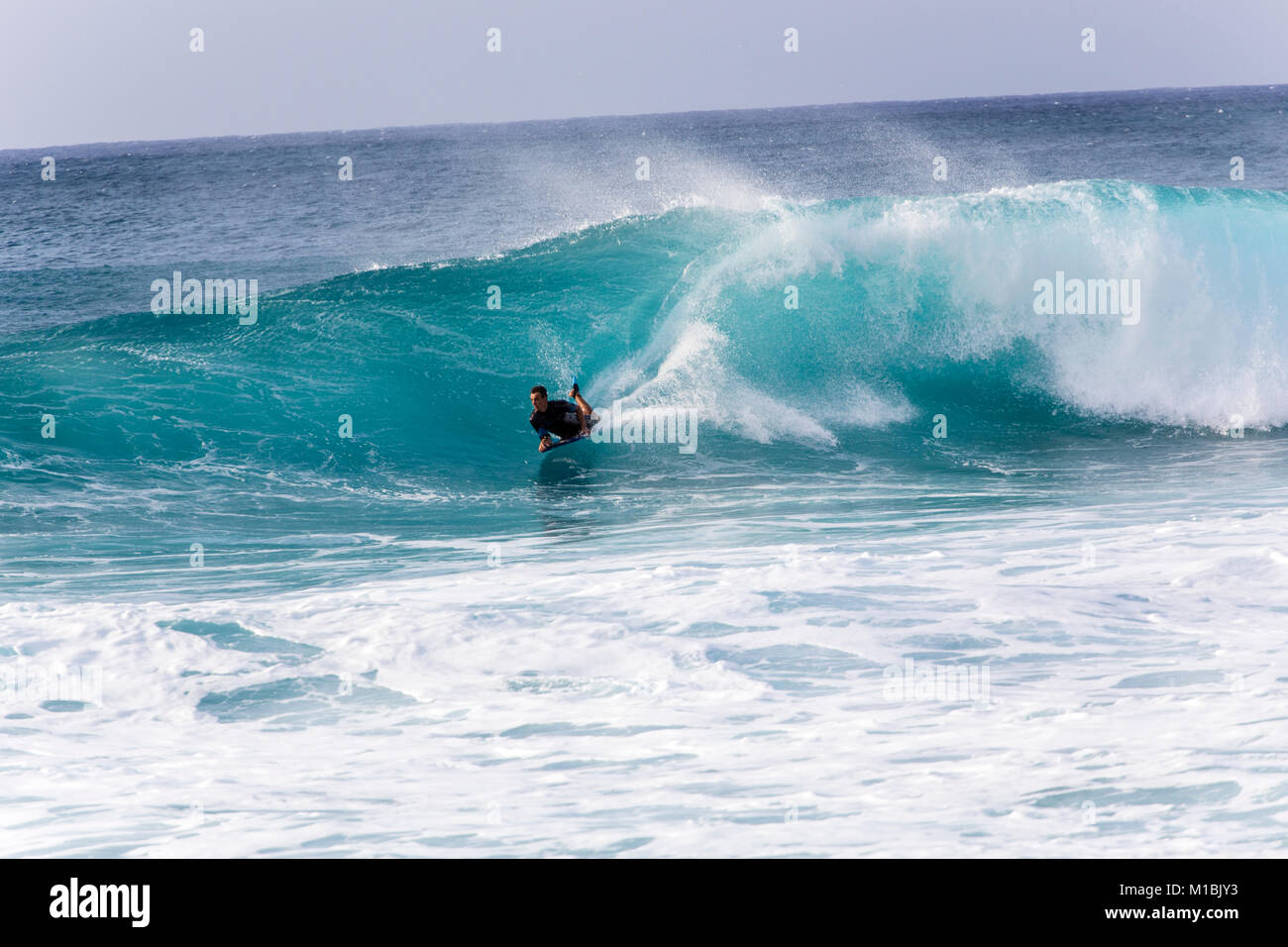 Banzai Pipeline, Oahu/Hawaii –February 27, 2017: A bodyboarder riding barrels of the Banzai Pipeline, a very popular pro-surf spot at the Northshore r Stock Photo