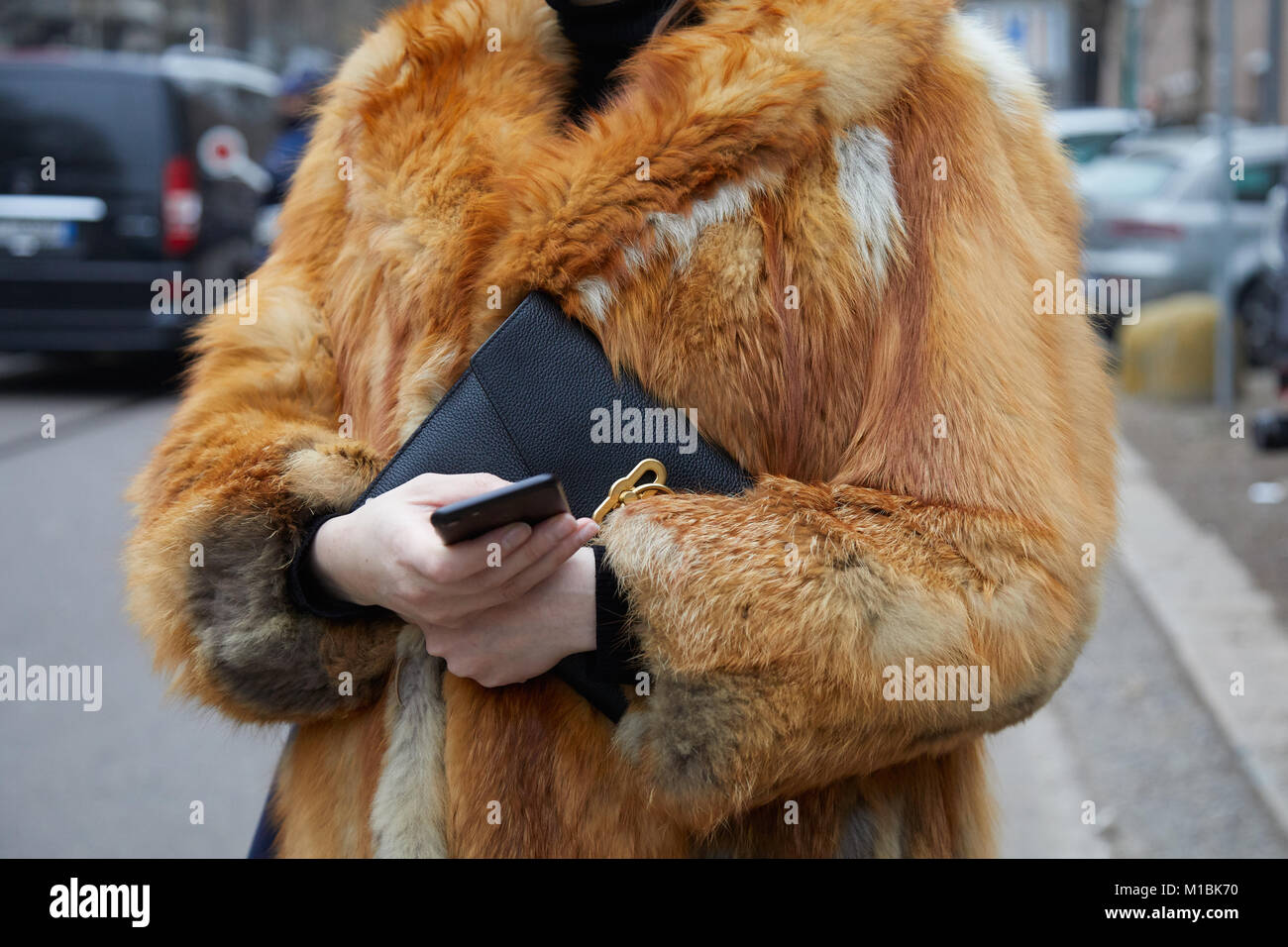 Woman with red fox fur coat looking at 
