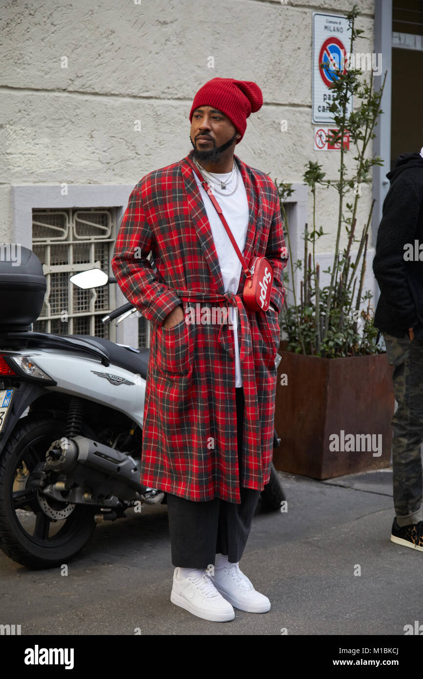 Man with red tartan coat and red Supreme Louis Vuitton bag on