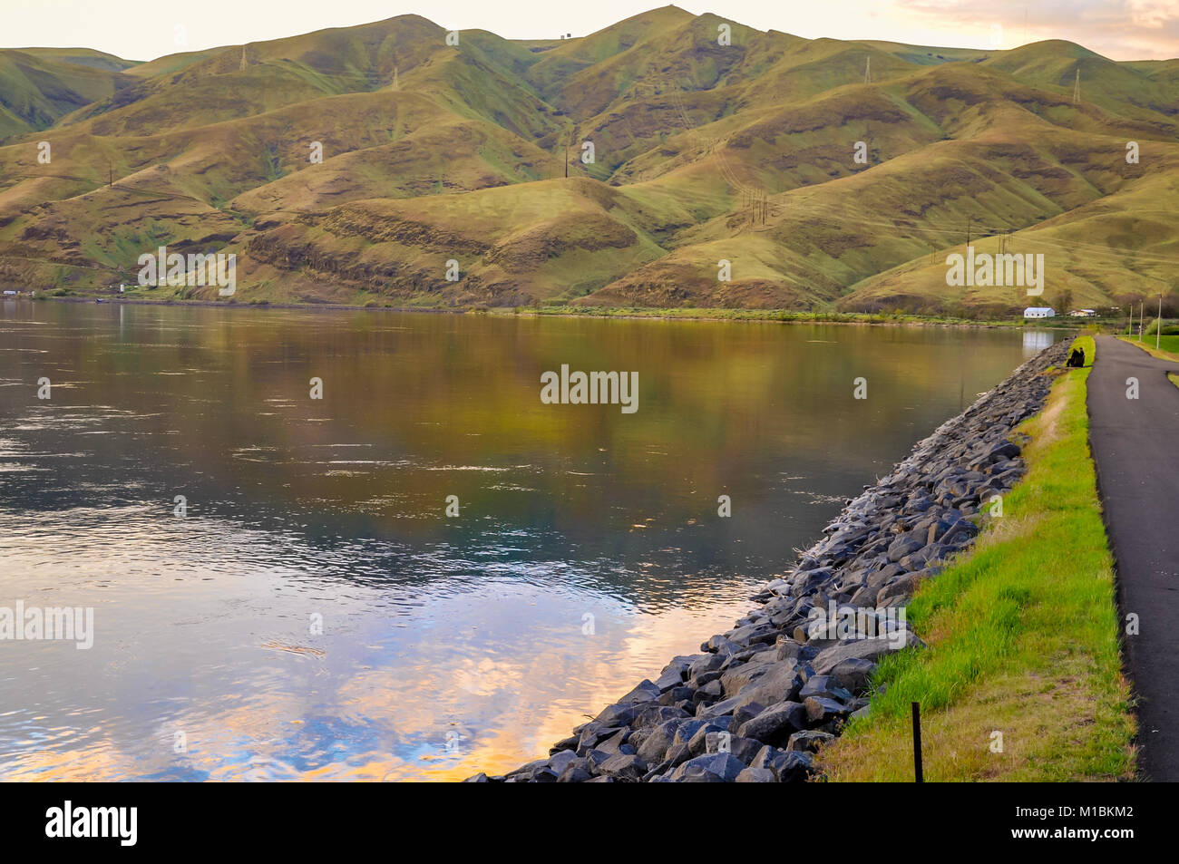 Lake at the base of foothills with promenade Stock Photo