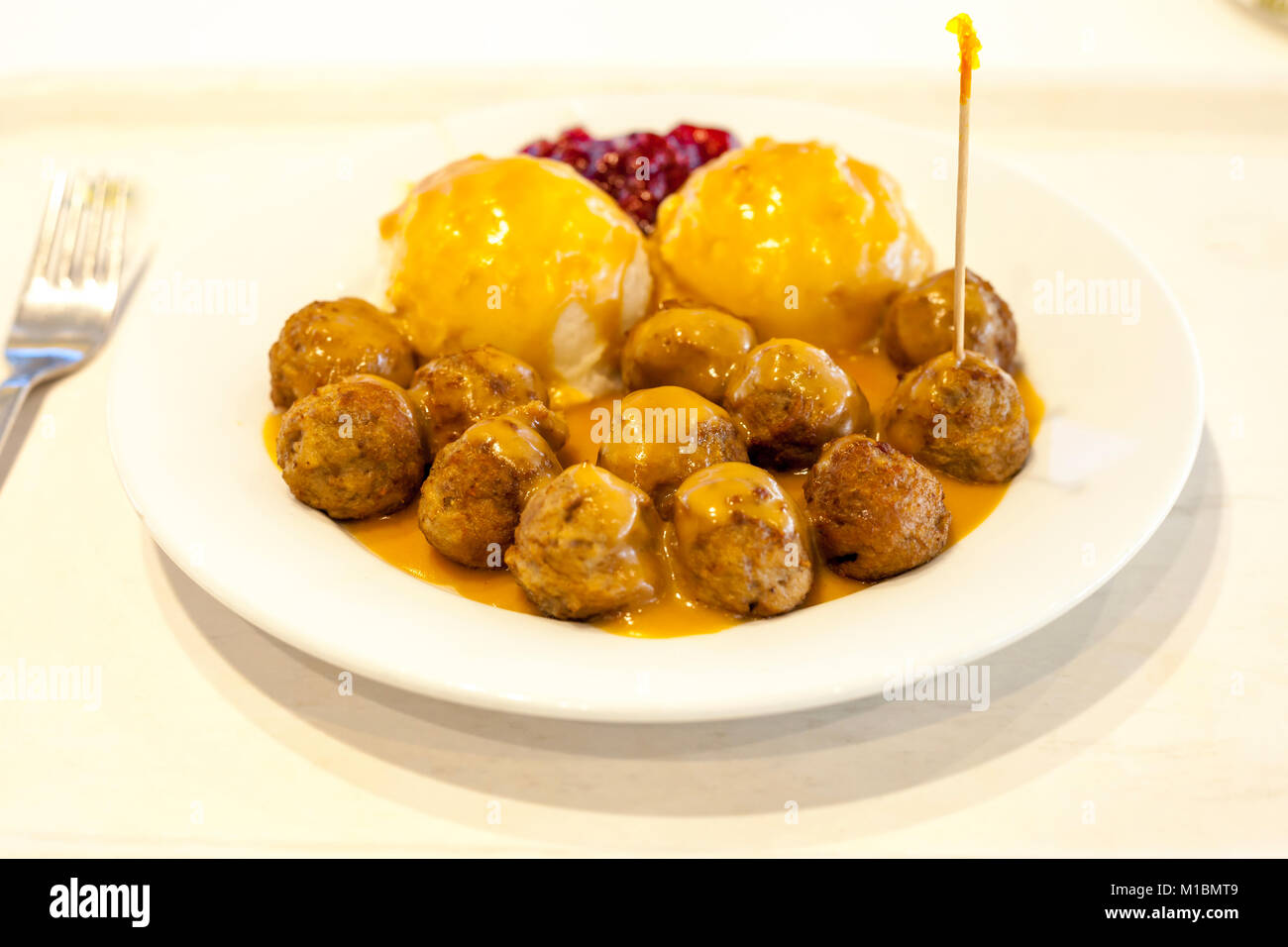 Plate of swedish meatballs with gravy and side of mash potatoes and lingonberry jam Stock Photo