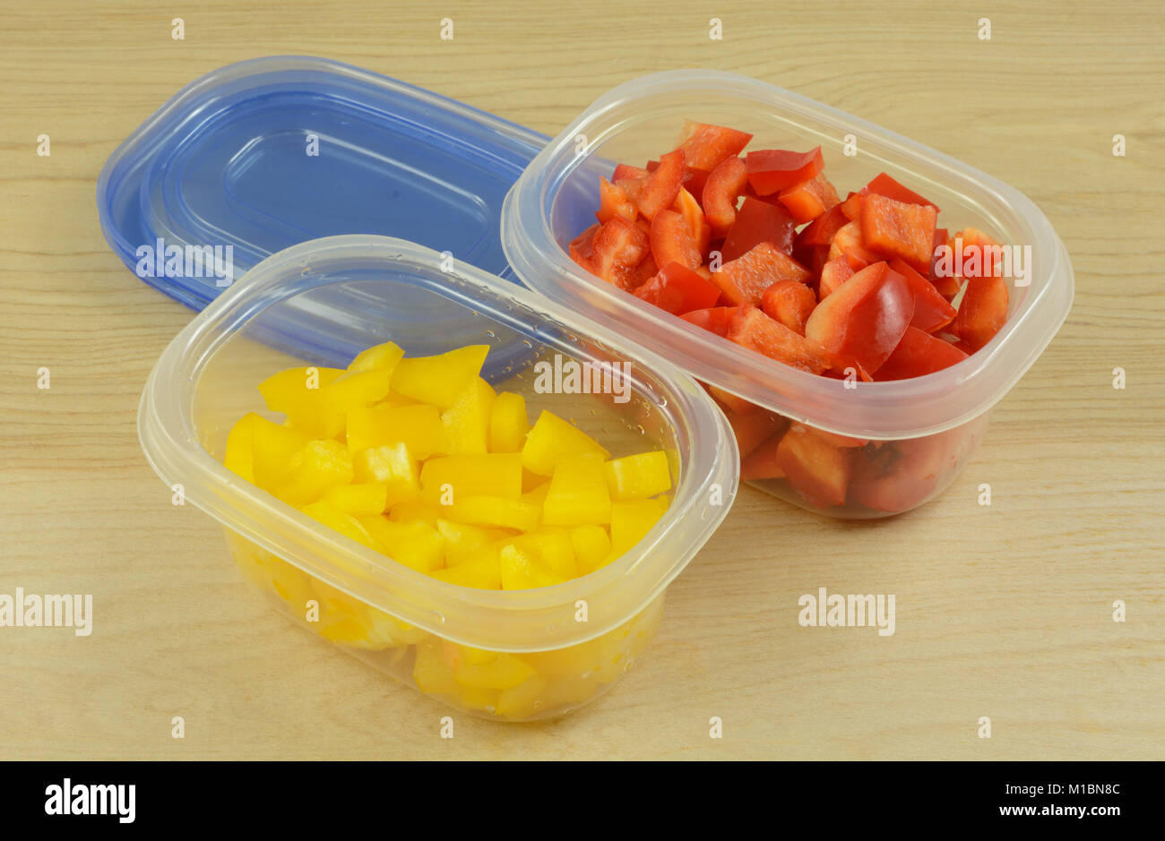 Chopped red and yellow bell peppers in plastic storage containers to organize of preparation or for planning in advance for quicker work week cooking Stock Photo