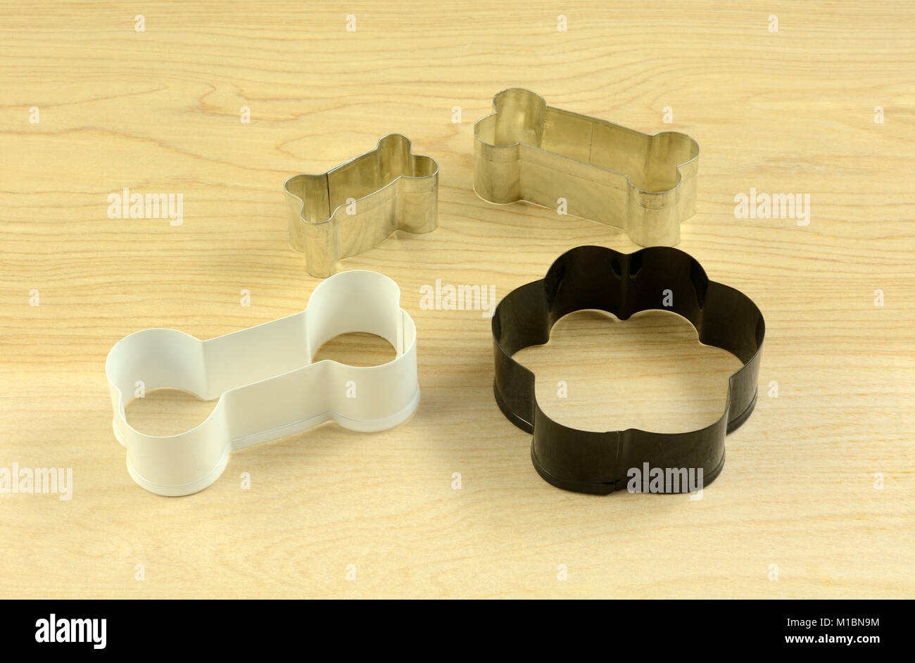 Dog themed cookie cutters in shapes of bones and of dog paw for making