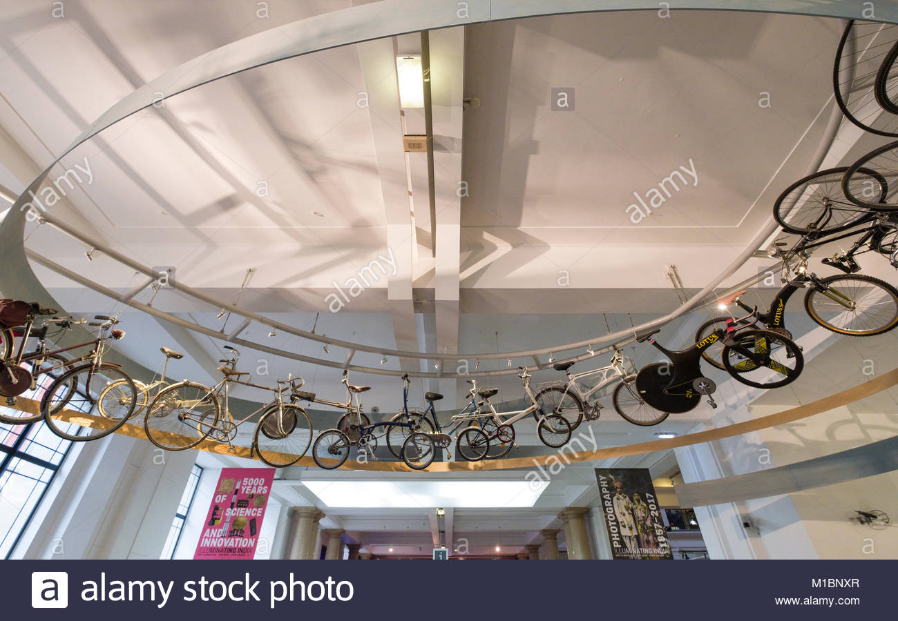 Various Types And Styles Of Bicycles Hanging From The