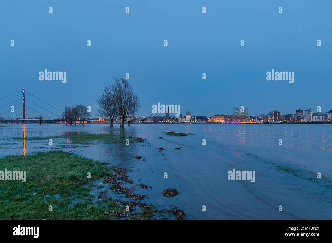Flood on the Rhine in front of Düsseldorf's Old Town during blue hour, Düsseldorf, North Rhine-Westphalia, Germany Stock Photo