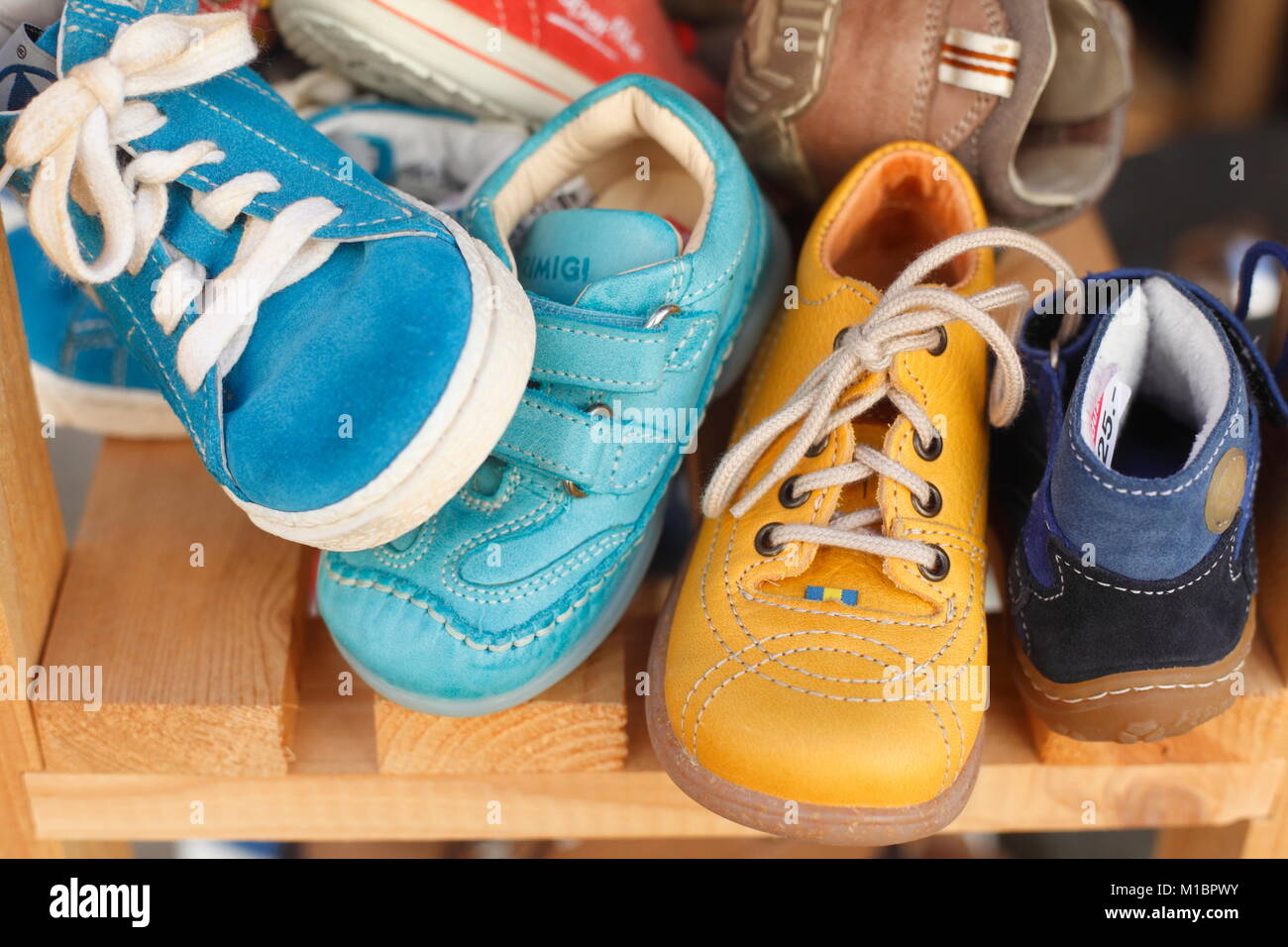 Children's shoes in a shelf, Germany Stock Photo