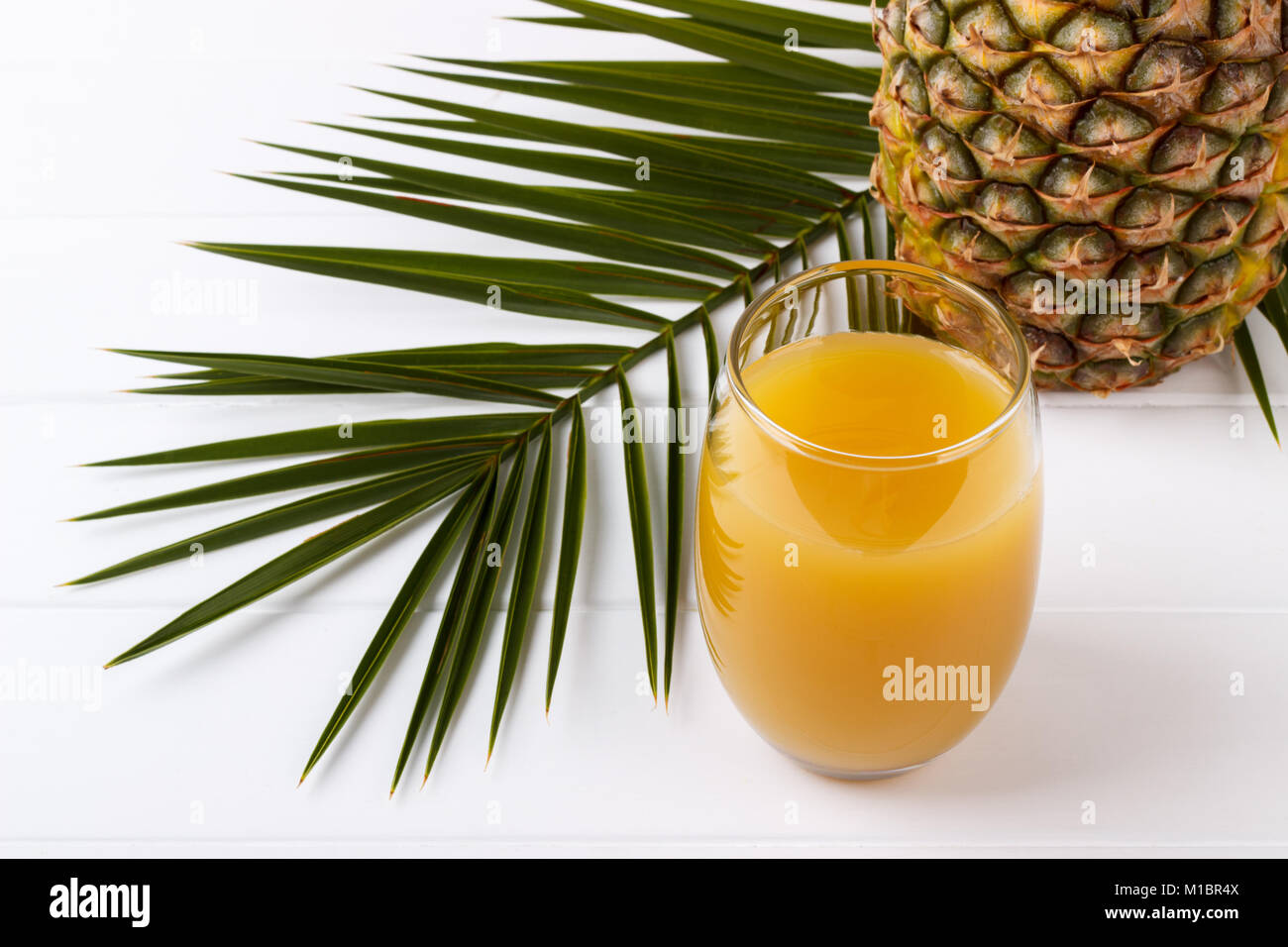glass of pineapple juice and whole fruit on white background Stock ...