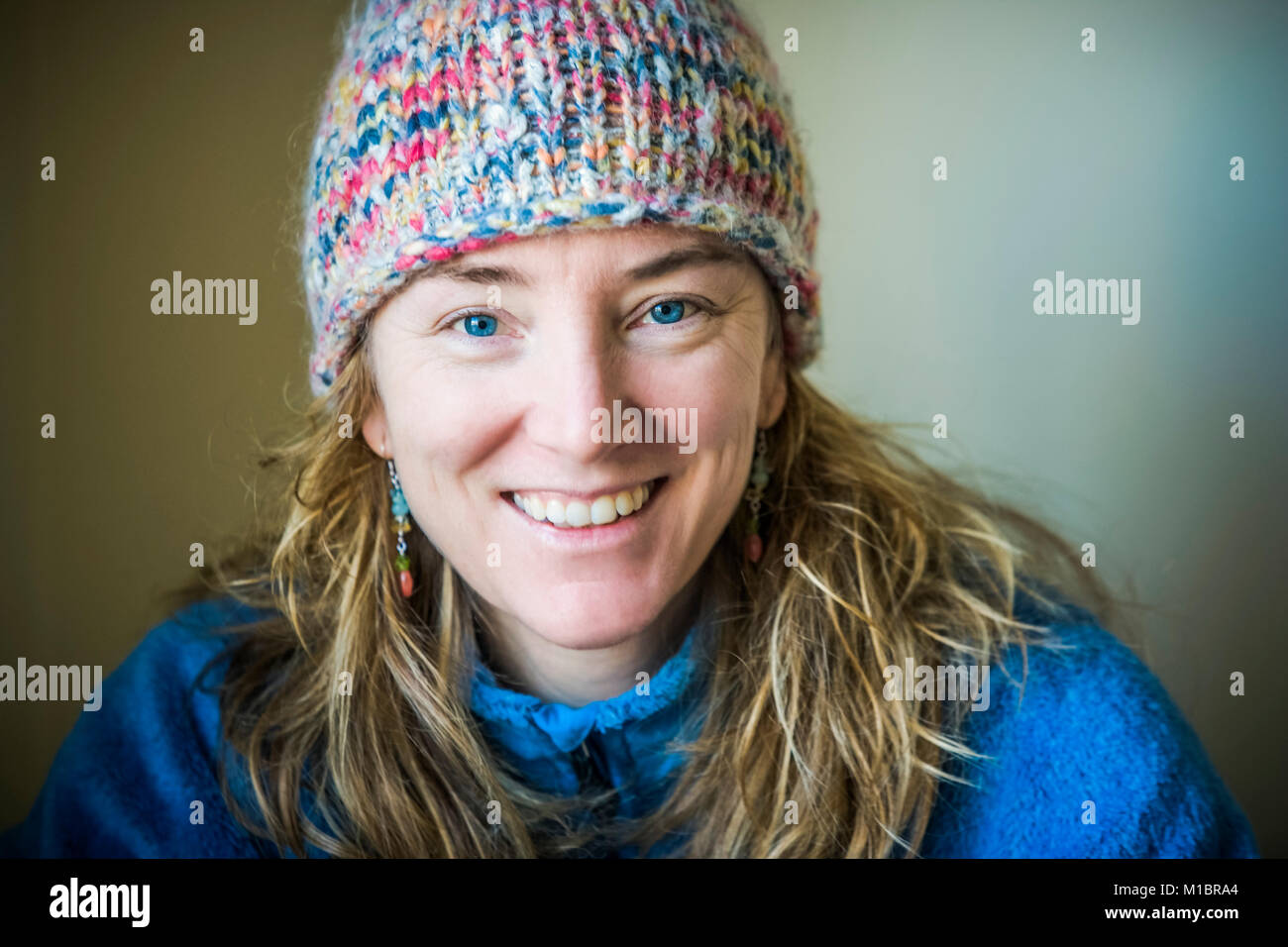 Smiling portrait of a late 30's woman in a knit hat and fleece jacket with long blond hair  20070115 MR A Stock Photo