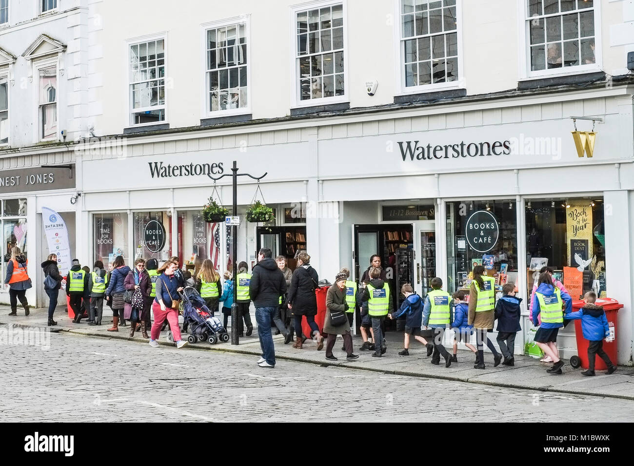 A large group of schoolchildren walking in Boscawen Street in Truro City Centre Cornwall. Stock Photo