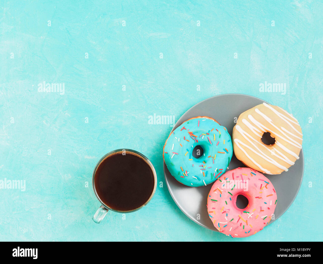 donuts on blue background , copy space, top view Stock Photo - Alamy
