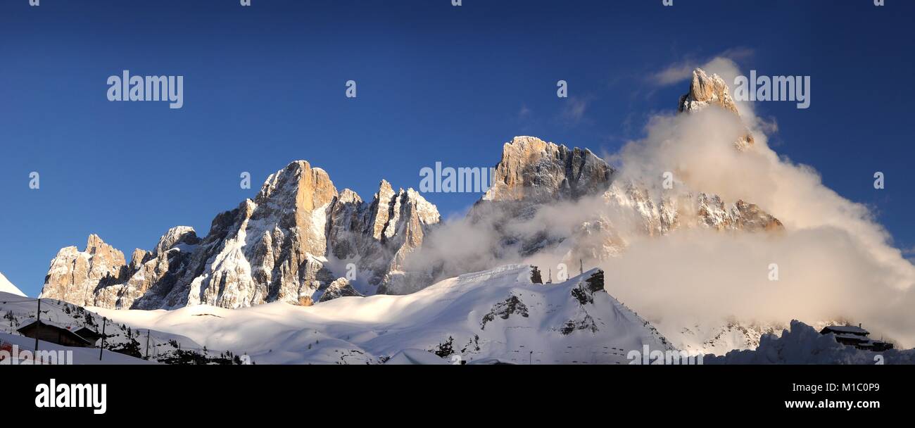 Scenic winter Landscape of Pale di San Martino group with the famous Cimon della Pala wrapped in clouds. San Martino di Castrozza Italy. Stock Photo