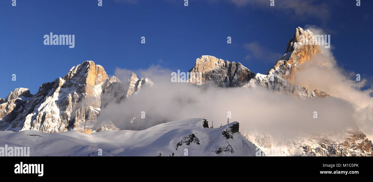 Scenic winter Landscape of Pale di San Martino group with the famous Cimon della Pala wrapped in clouds. San Martino di Castrozza Italy. Stock Photo