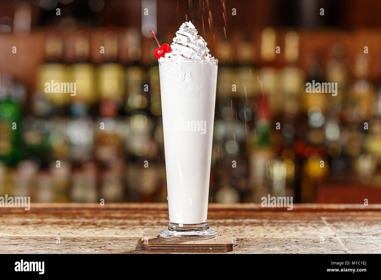 Liquor, ice cream and cream in a blender with half a cup of crushed ice