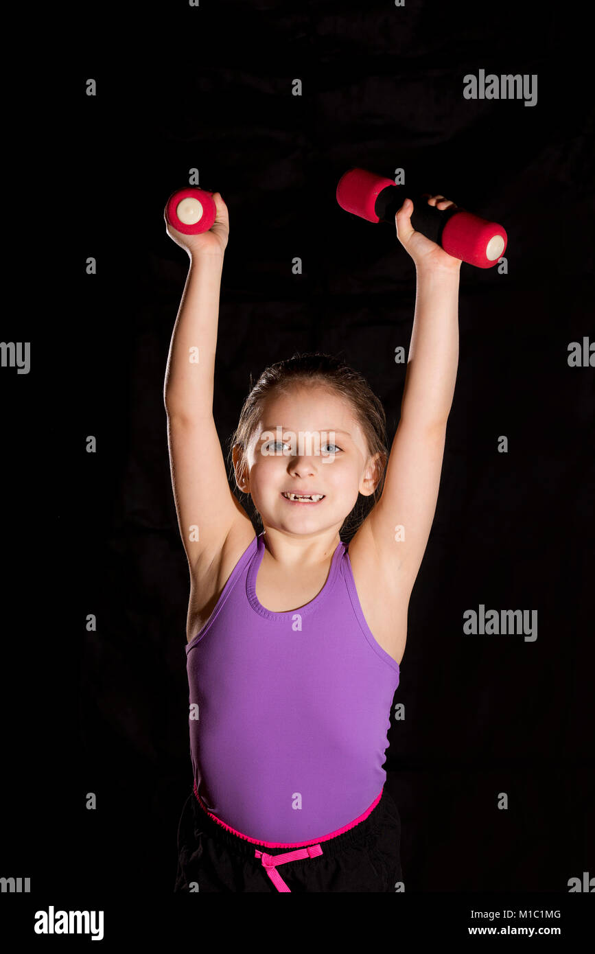 Little caucasian girl with dumbbells Stock Photo - Alamy