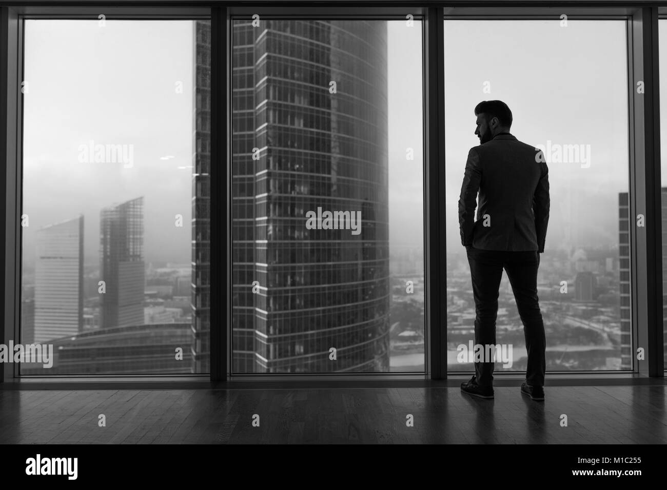 Man looking out of window - Stock Image - F009/8001 - Science