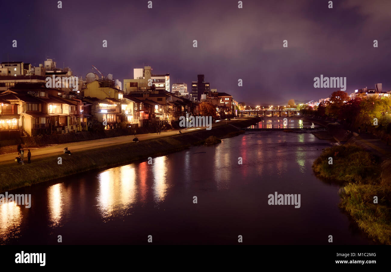 Kyoto nighttime city scenery of Kamo River, Kamo-gawa, with street lights reflecting in water and Sanjo bridge in the background. Kyoto, Japan 2017. Stock Photo