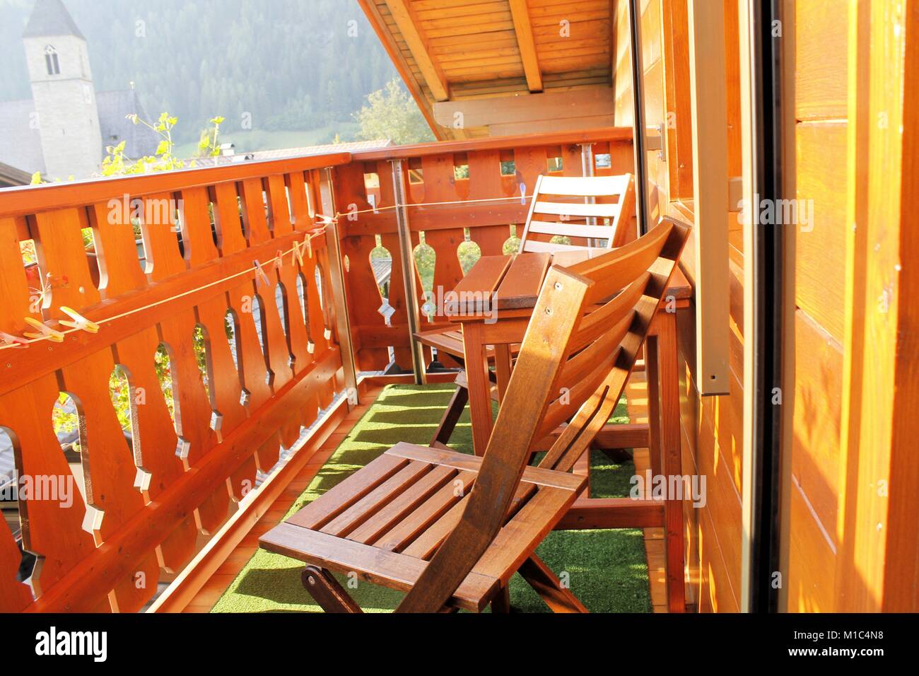 wooden balcony with table and two chairs Stock Photo - Alamy