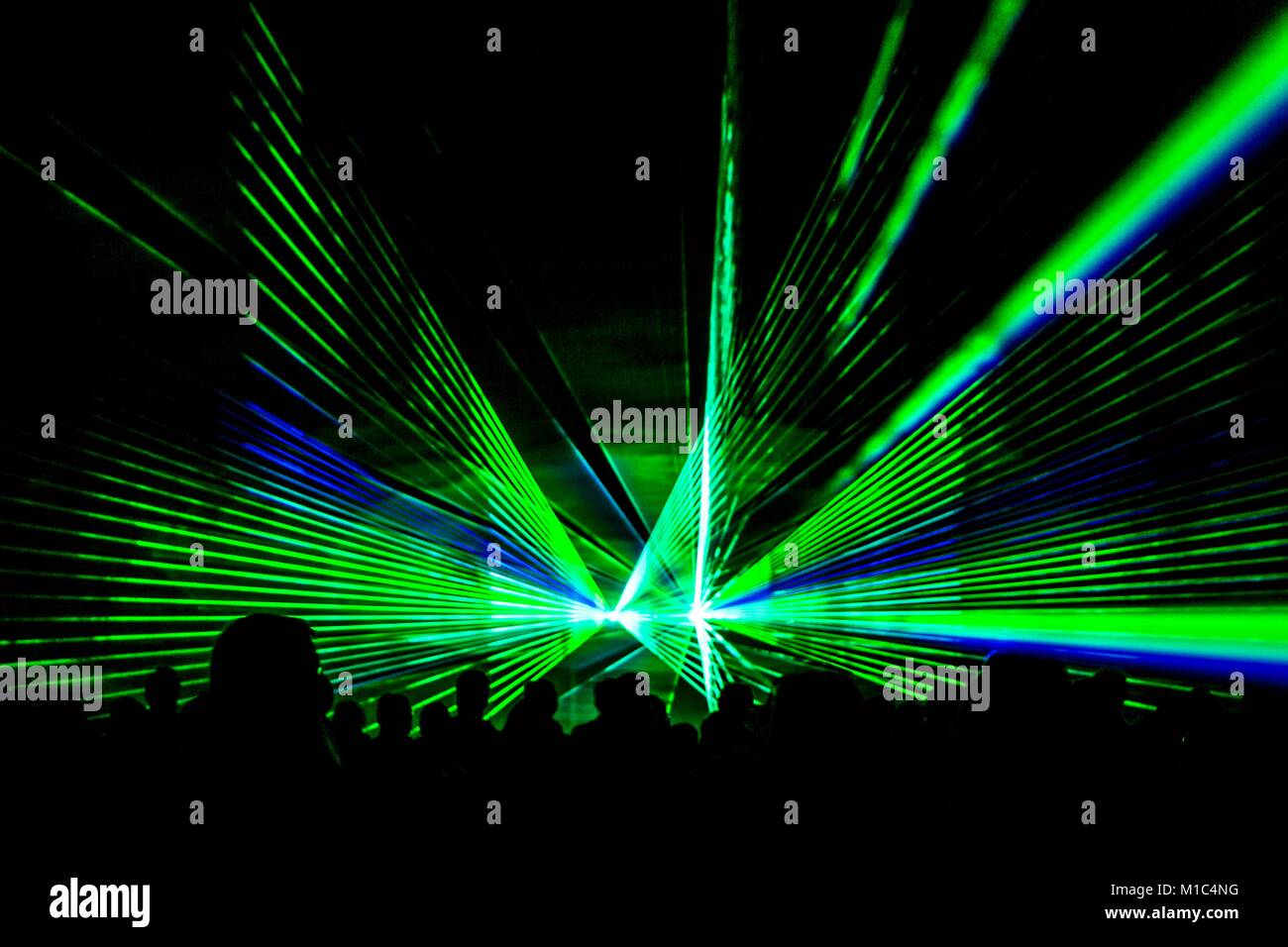 Green laser show nightlife club stage with party people crowd. Luxury  entertainment audience silhouettes in nightclub event, festival or New Year  Eve Stock Photo - Alamy