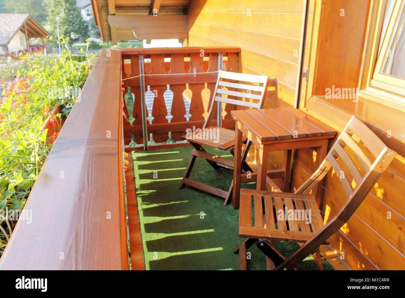 wooden balcony with table and two chairs Stock Photo - Alamy