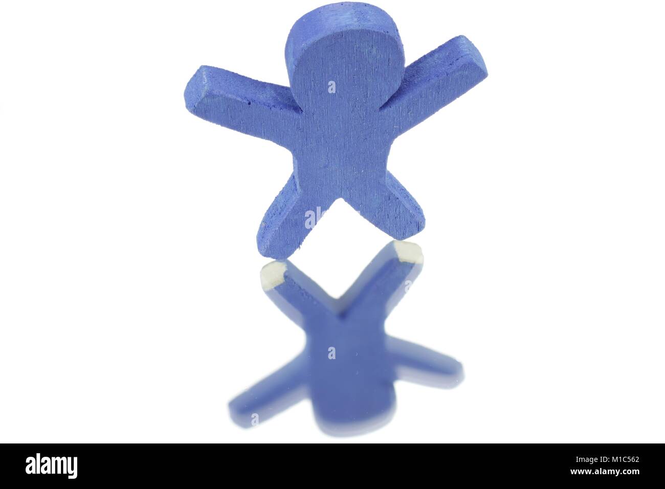Little blue male in front of white background and reflection Stock Photo