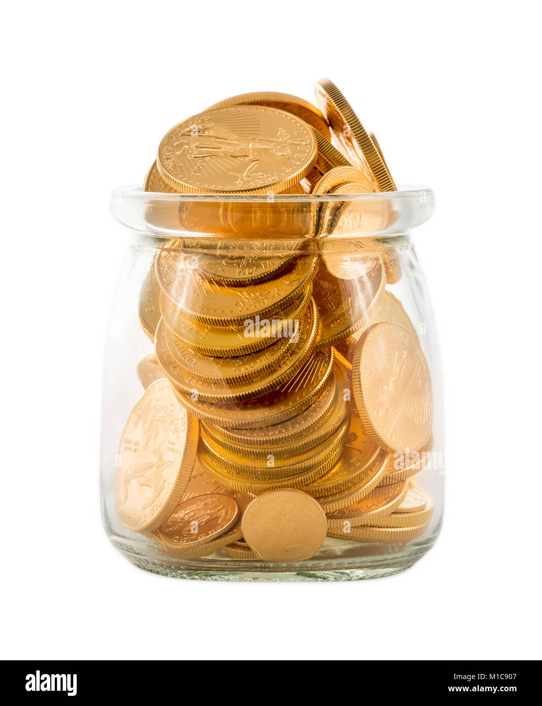 Gold coins inside glass jar to represent savings or investments Stock Photo
