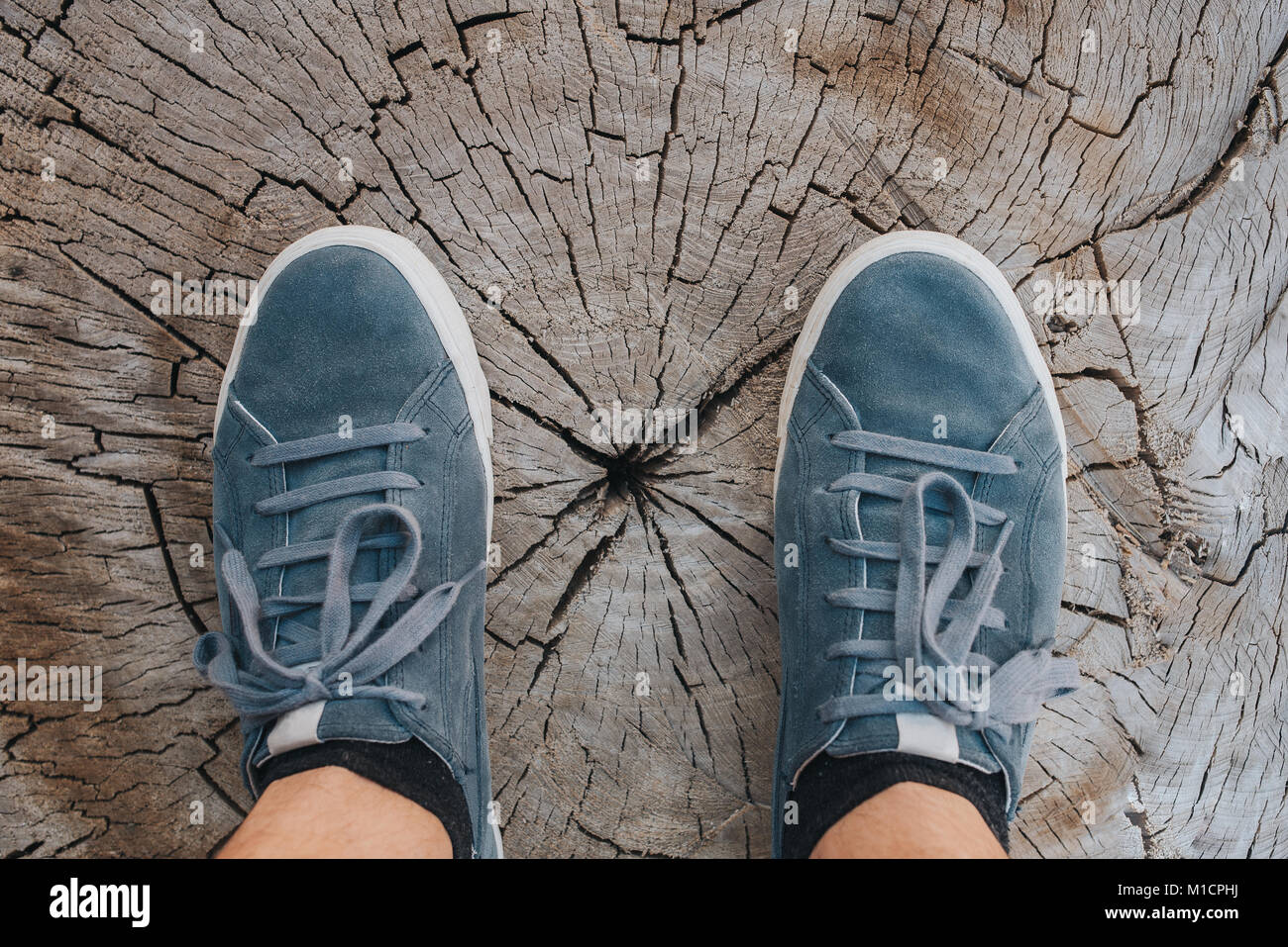 Blue leather sneakers on wood background, top view, fashion lifestyle concept Stock Photo