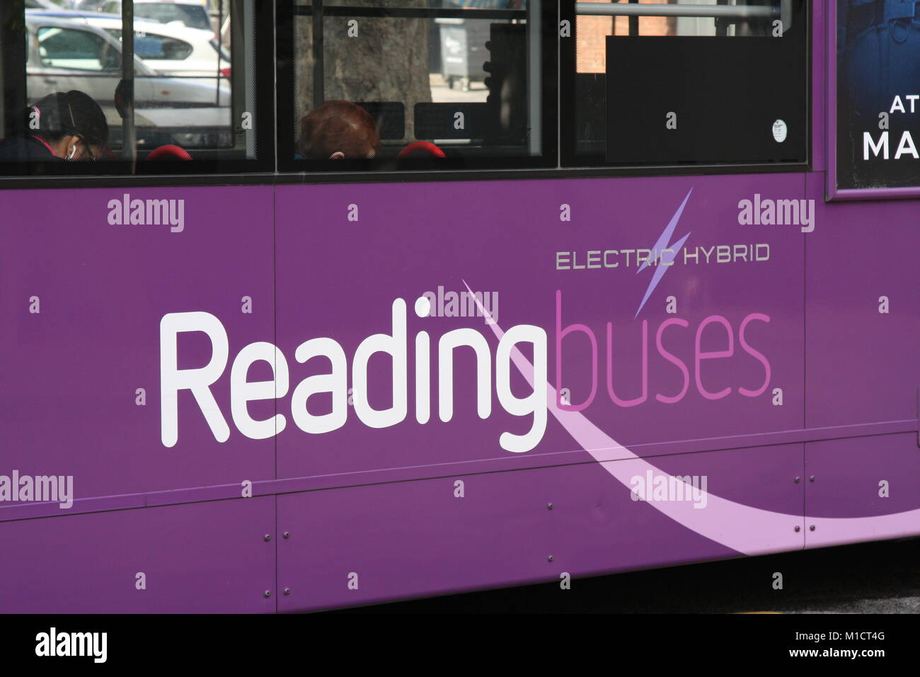 CLOSE-UP VIEW OF PURPLE READING BUSES LIVERY SHOWING FLEETNAME AND ELECTRIC HYBRID LOGO Stock Photo