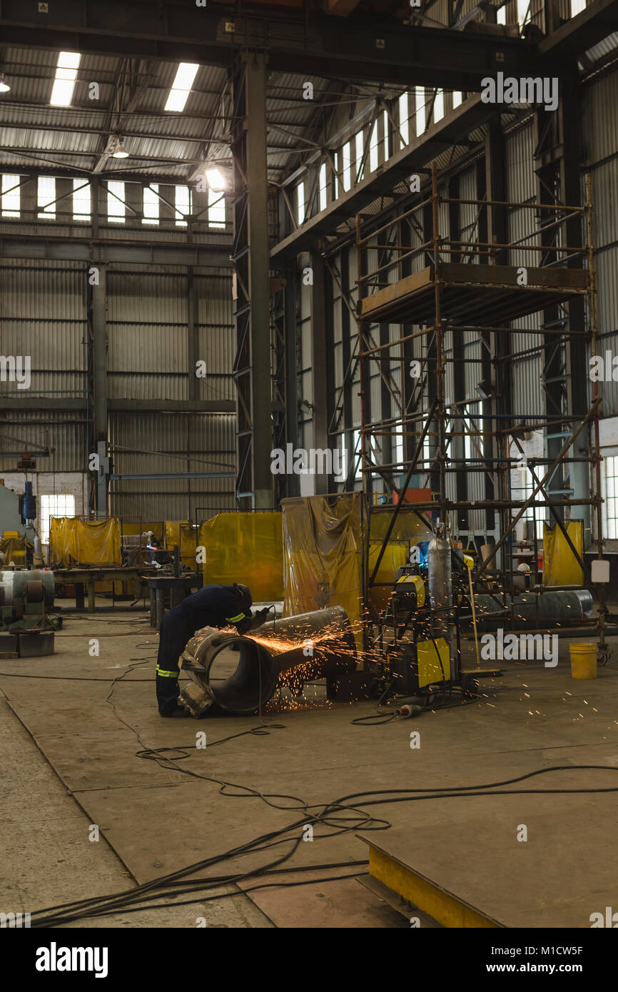 Welder repairing vessel part Stock Photo