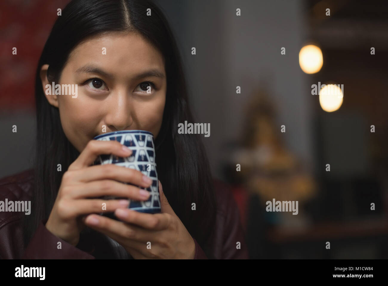 Woman having green tea in restaurant Stock Photo Alamy