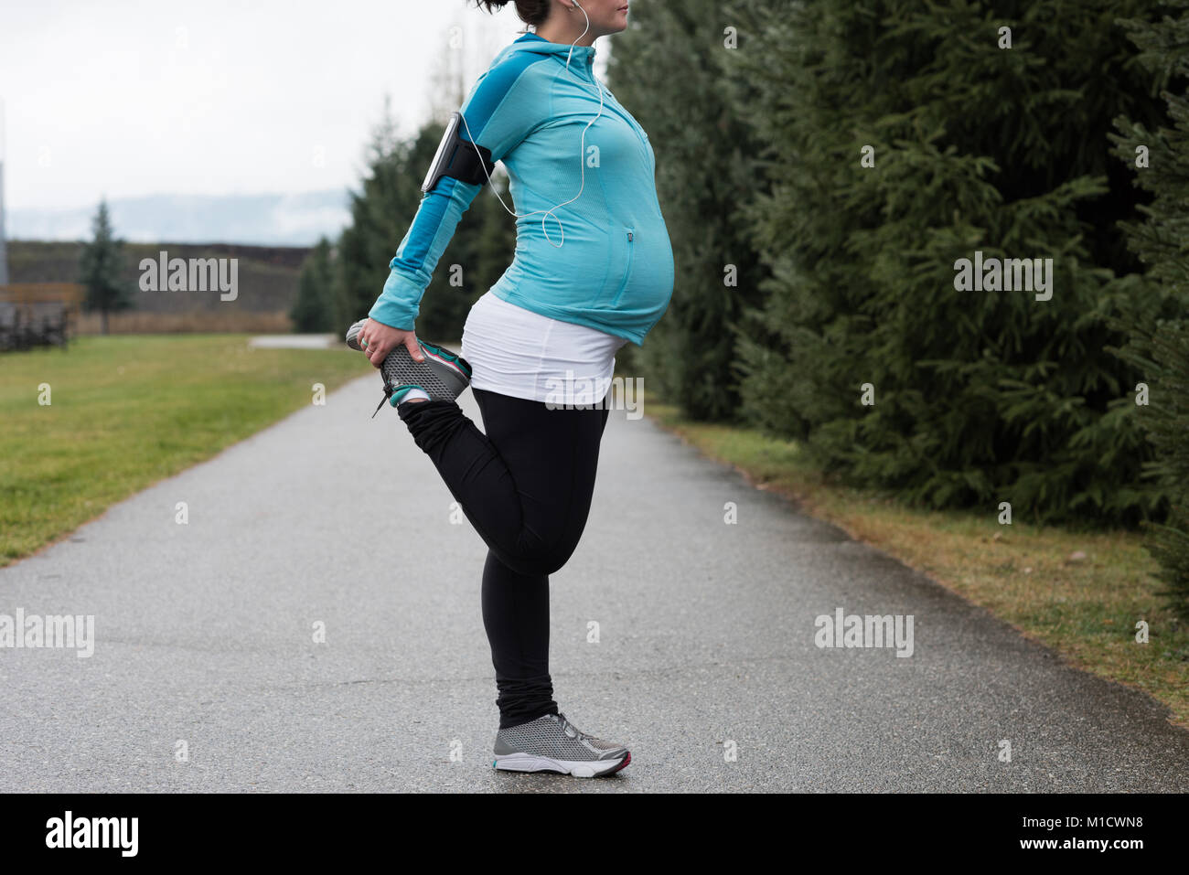 Picture of Pregnant woman performing stretching exercising Stock Photo - Alamy