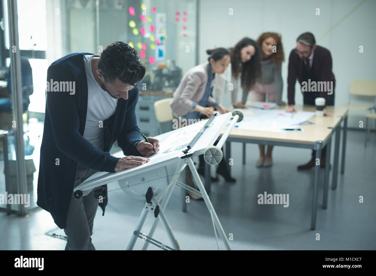 Male executive working over drafting table Stock Photo