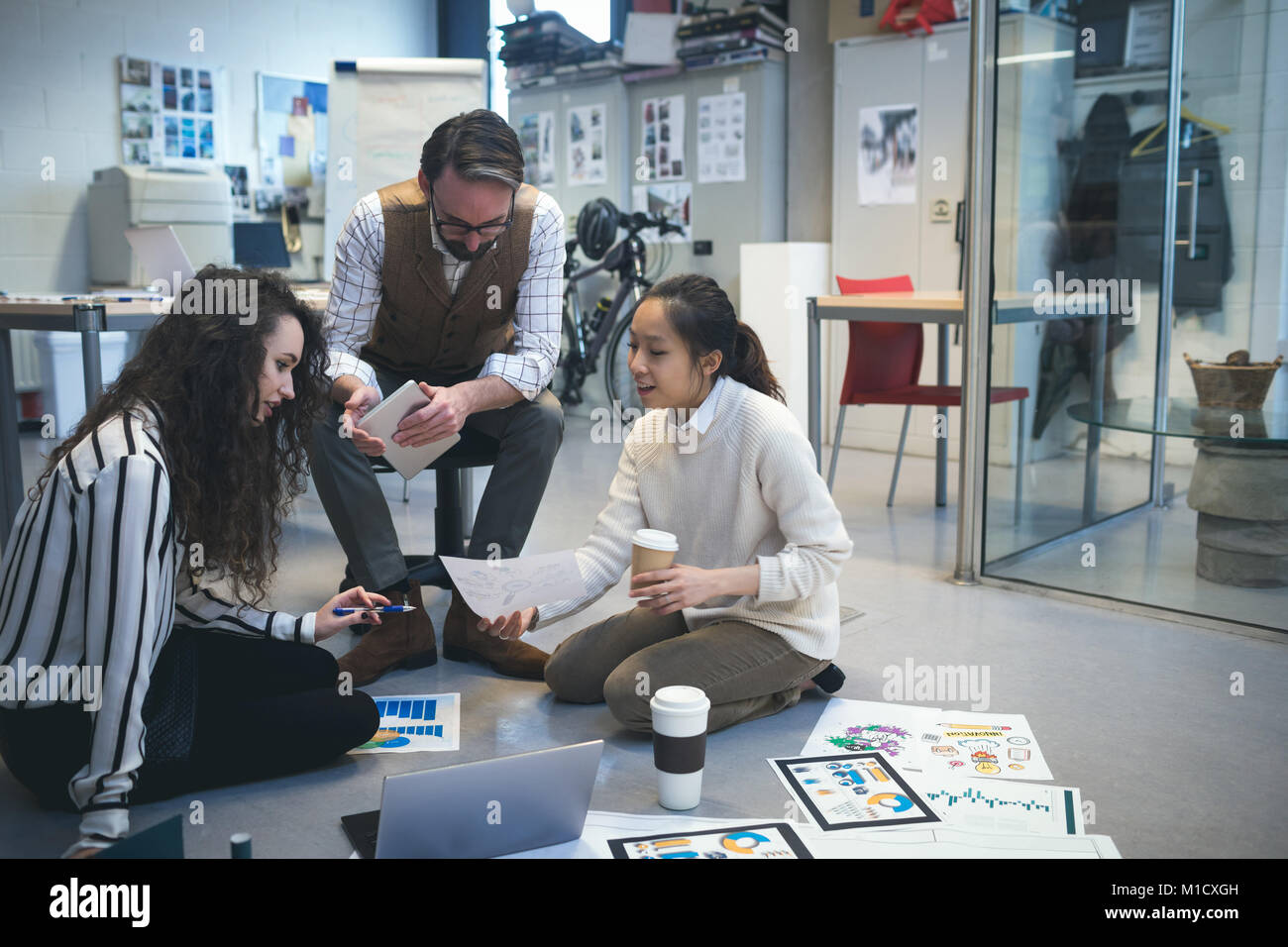 To Discuss Over Executives discussing over document Stock Photo - Alamy