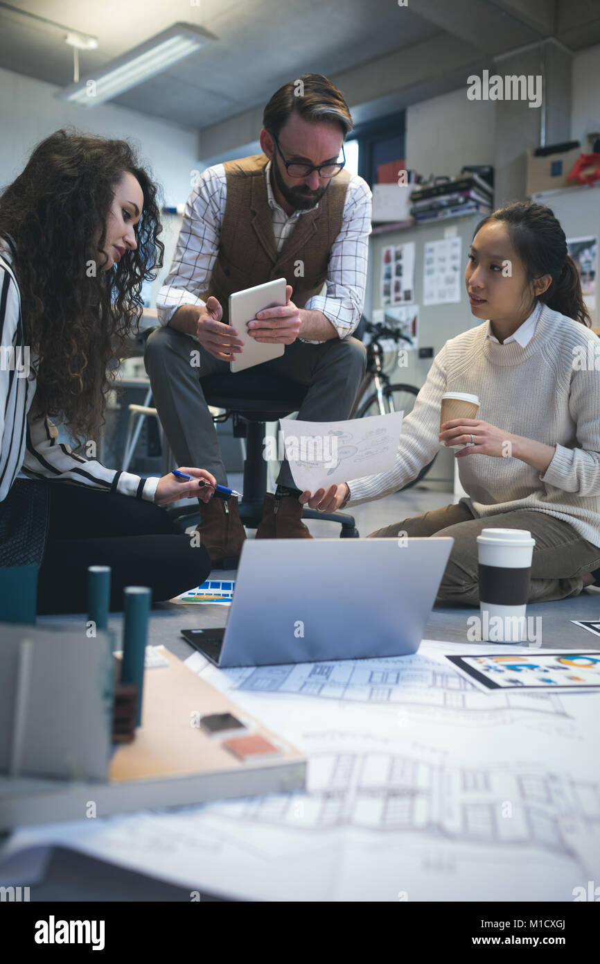 To Discuss Over Executives discussing over document Stock Photo - Alamy