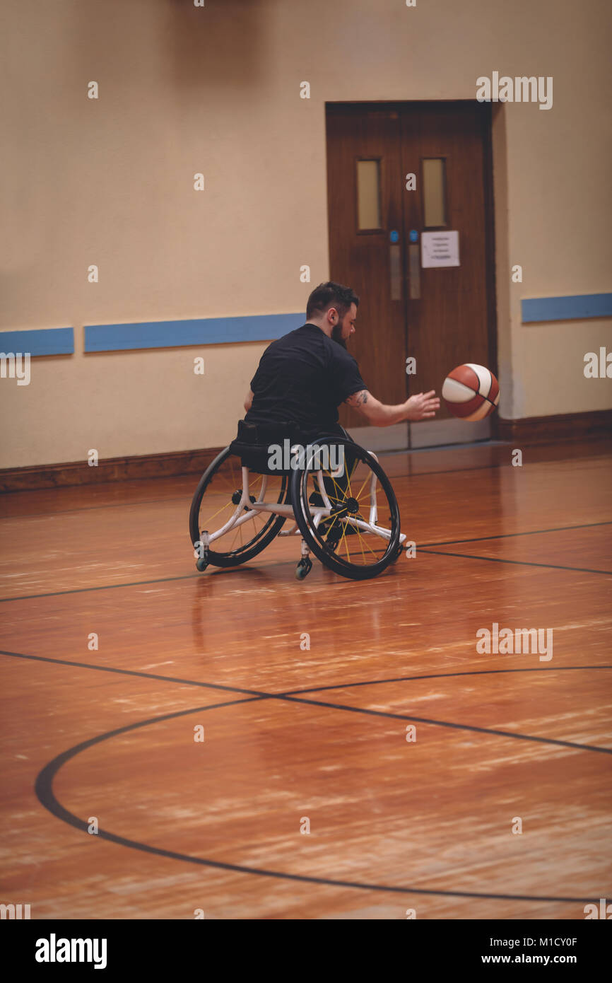 Disabled man practicing basketball in the court Stock Photo