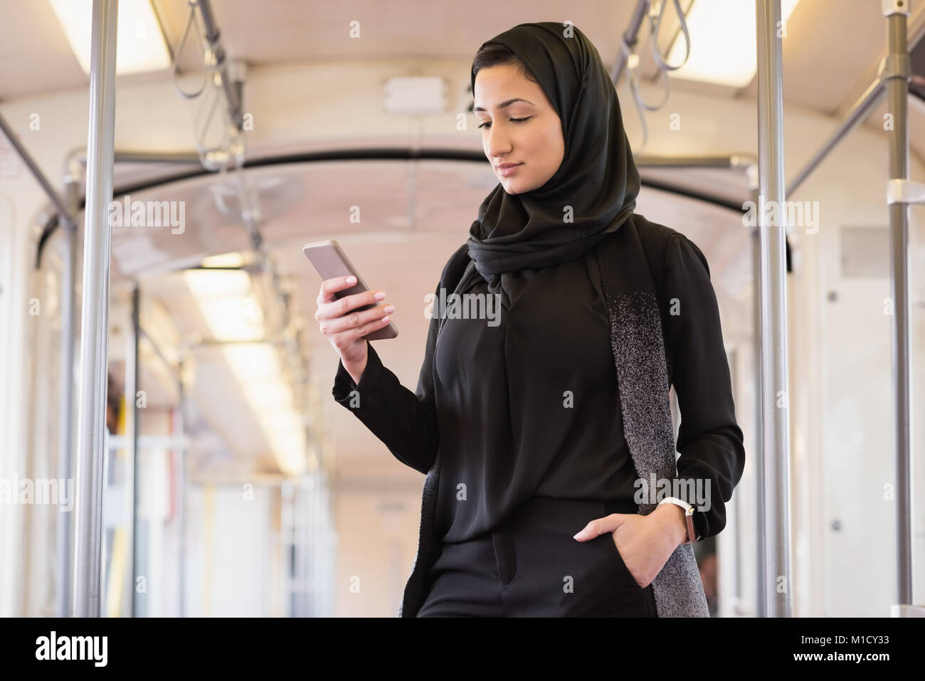Woman in hijab using mobile phone Stock Photo - Alamy