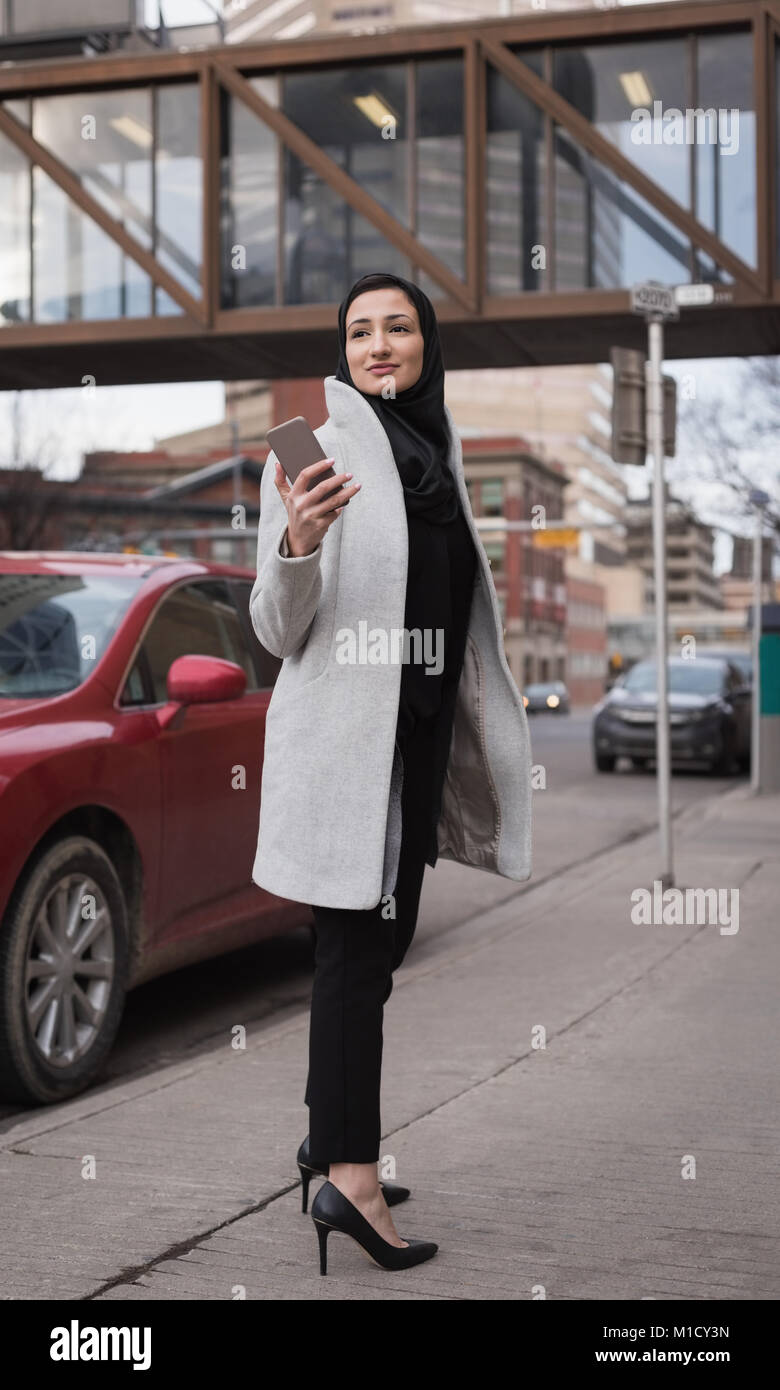 Woman in hijab using mobile phone Stock Photo - Alamy