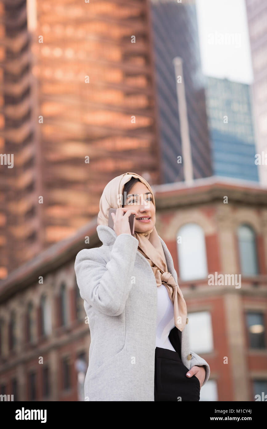 Woman in hijab talking on mobile phone Stock Photo