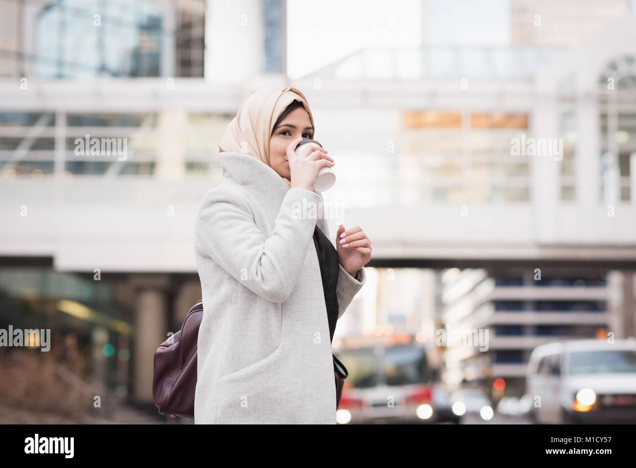 Woman in hijab drinking coffee Stock Photo