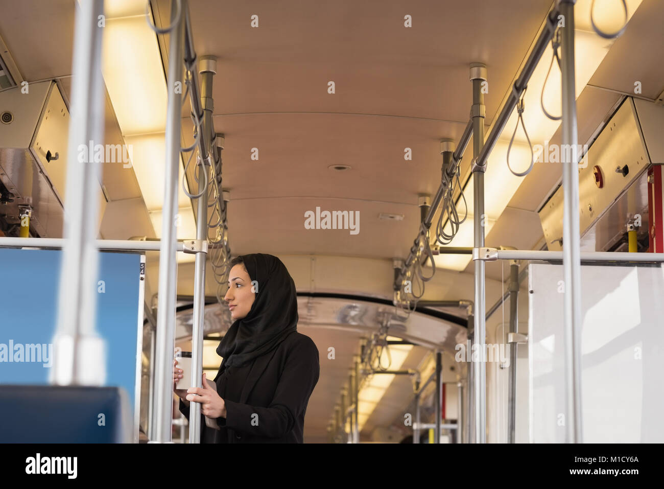 Woman in hijab travelling in train Stock Photo