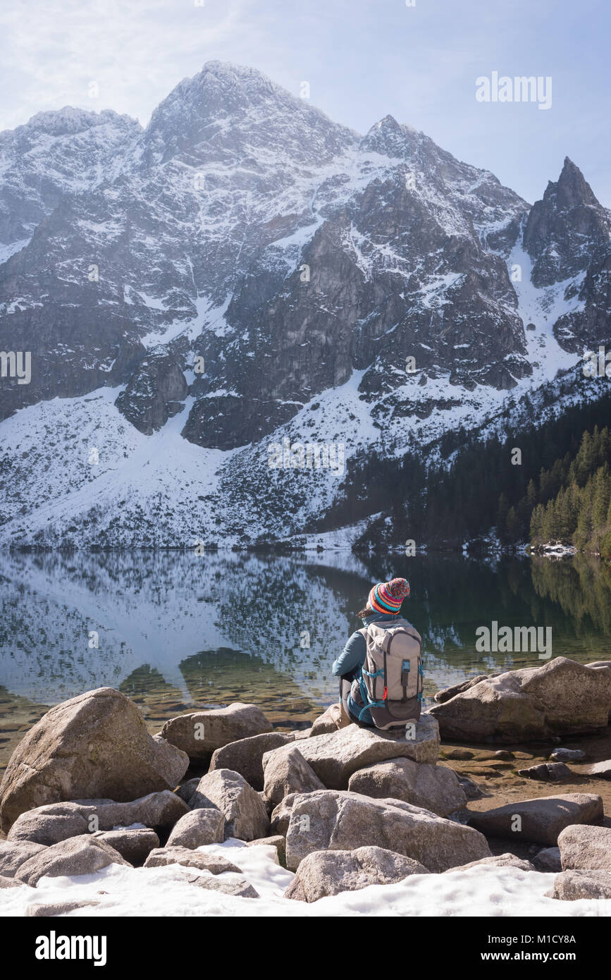Female hiker looking at snow capped mountain Stock Photo