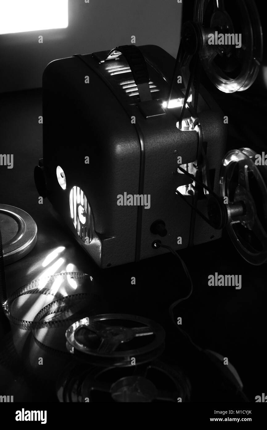 Old film projector and a glowing screen in the dark Stock Photo Alamy