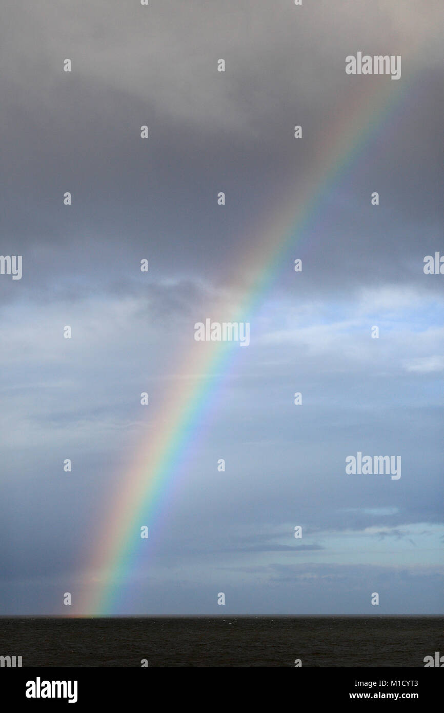 Rainbow over the sea. Stock Photo