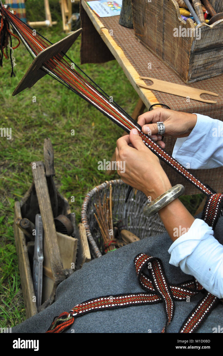 Hand weaving on a medieval festival Stock Photo