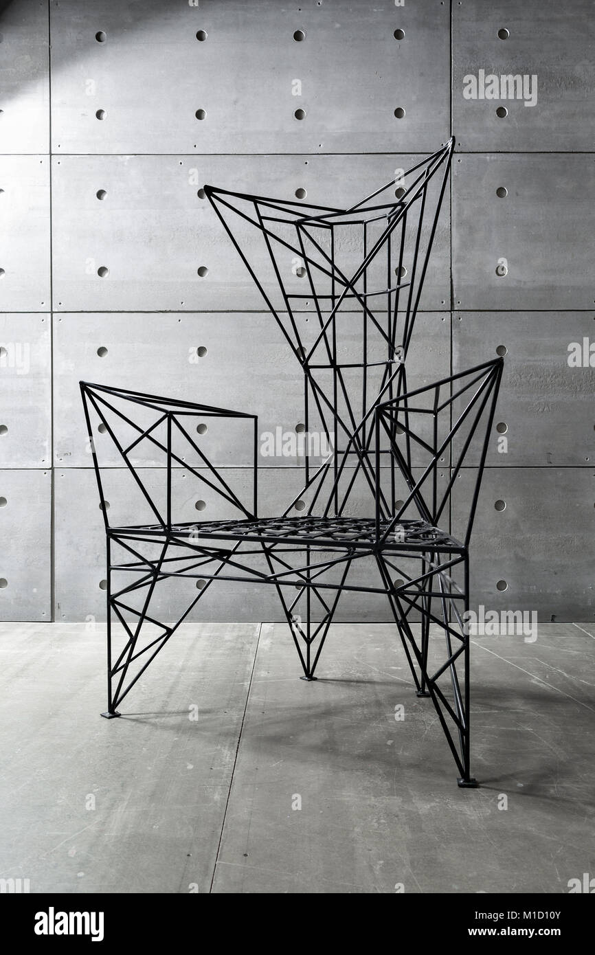 modern metal chair and concrete wall. copy space Stock Photo Alamy