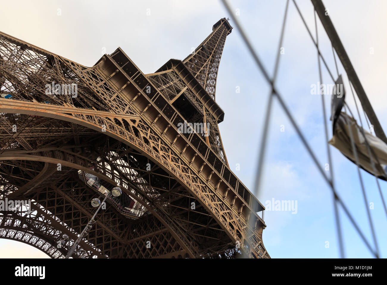 The Eiffel Tower is surrounded by security fences whilst a new glass