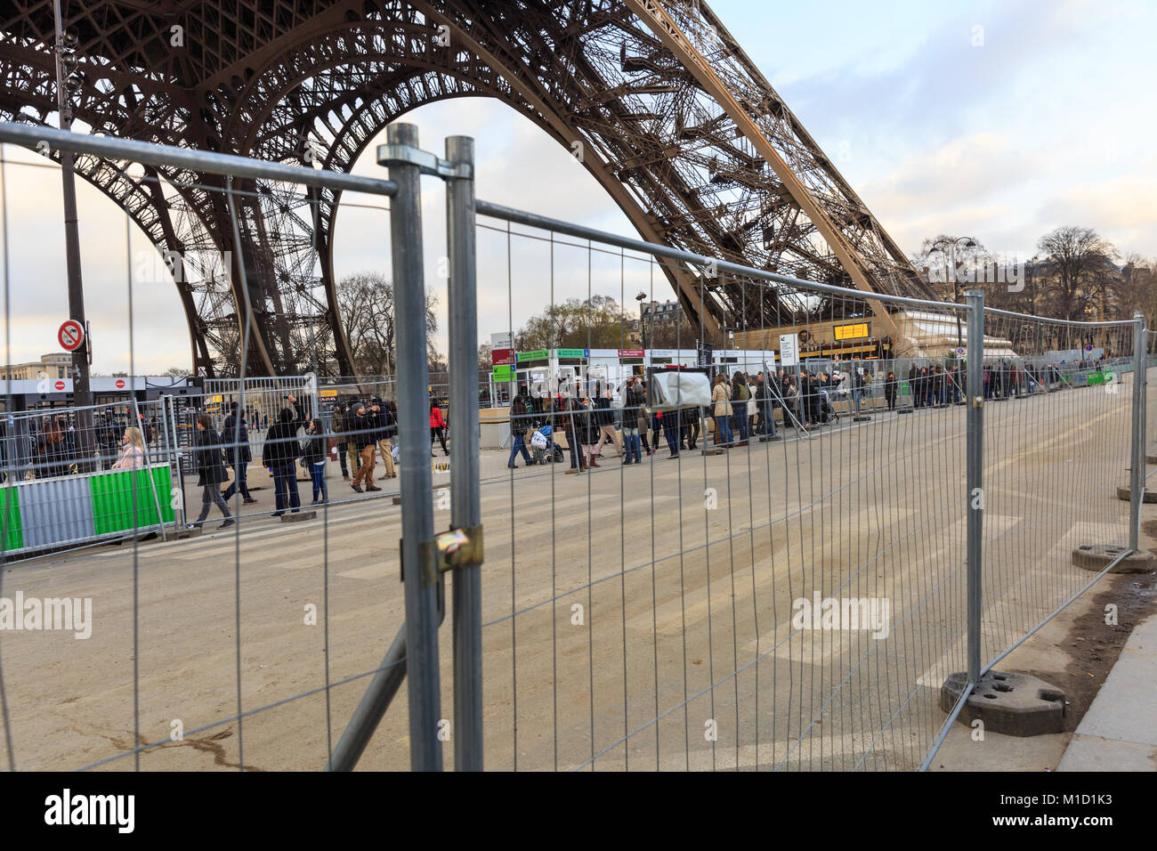 The Eiffel Tower is surrounded by security fences whilst a new glass wall is being erected, Paris, France Stock Photo