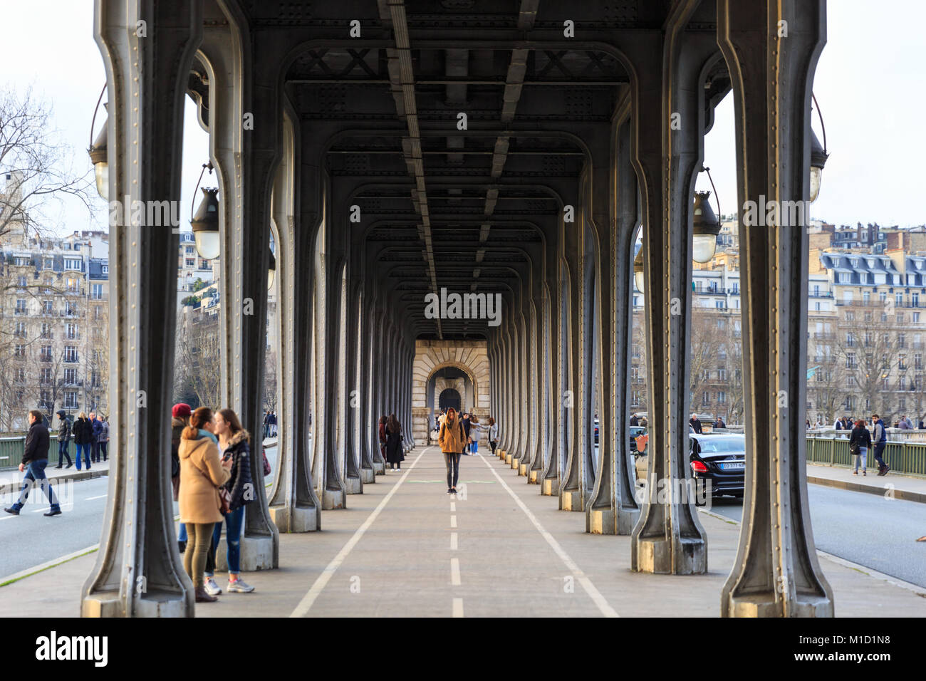 People walking on the pedestrian and car level of the Pont de Bir-Hakeim, formerly the Pont de Passy, Paris, France Stock Photo
