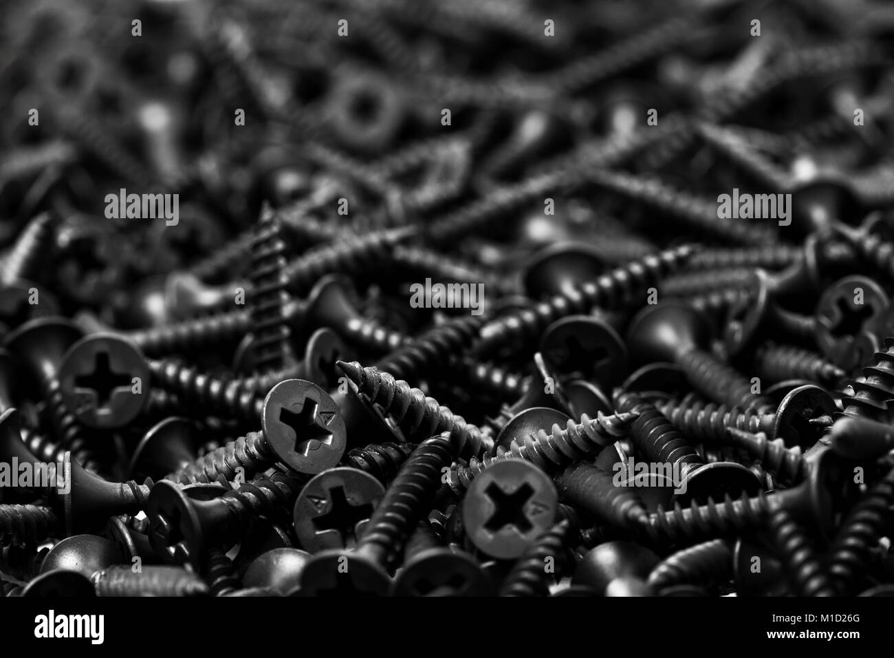 group of black screws for fixing drywall on metal profiles, letter A