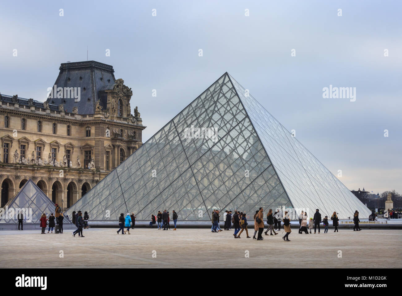 People at the glass pyramid (Pyramide du Louvre) entrance to the Louvre museum in Paris, France Stock Photo