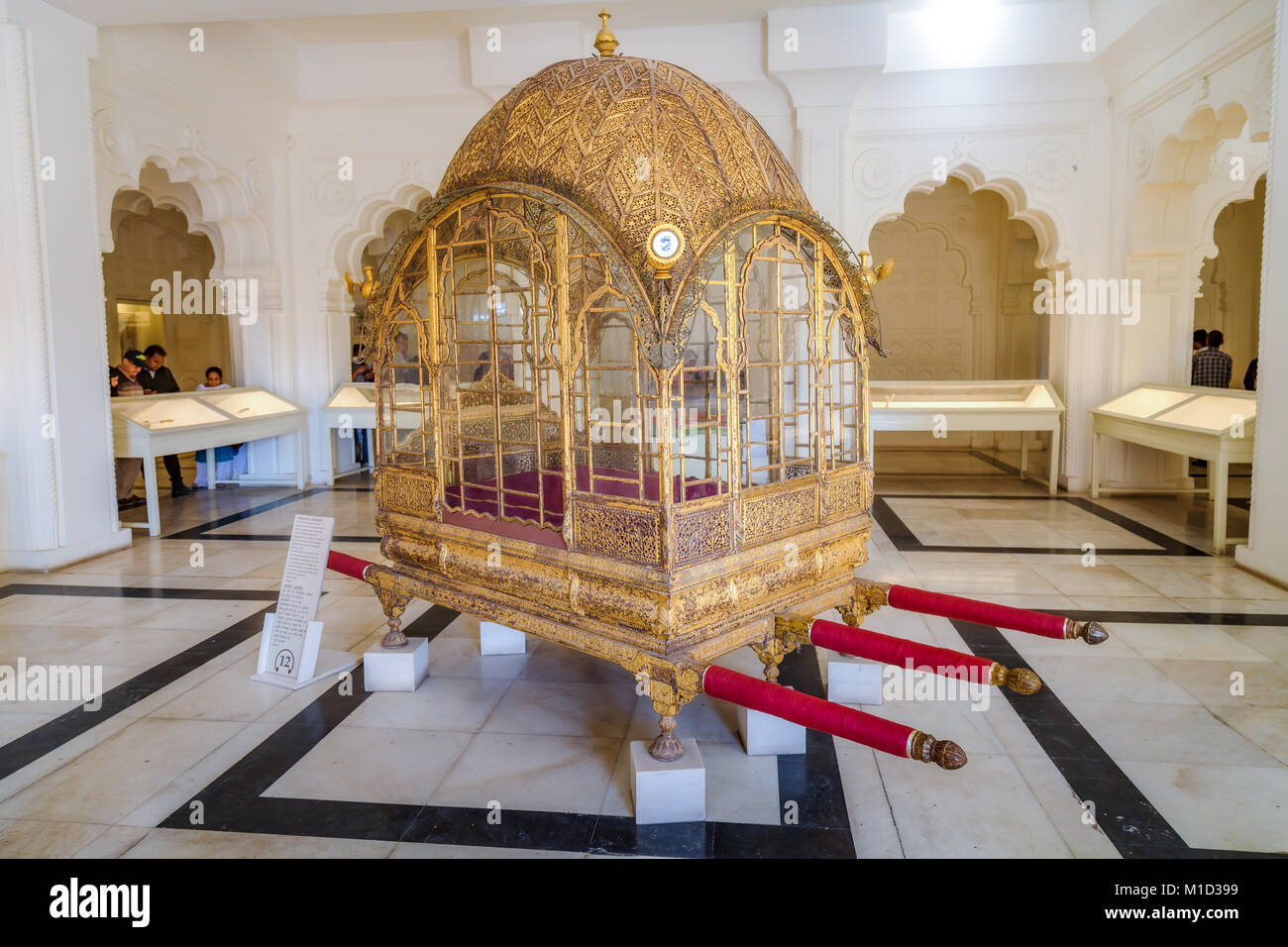 Ancient royal gold palanquin (mode of transportation) on display at the museum in Mehrangarh Fort, Jodhpur, Rajasthan India. Stock Photo